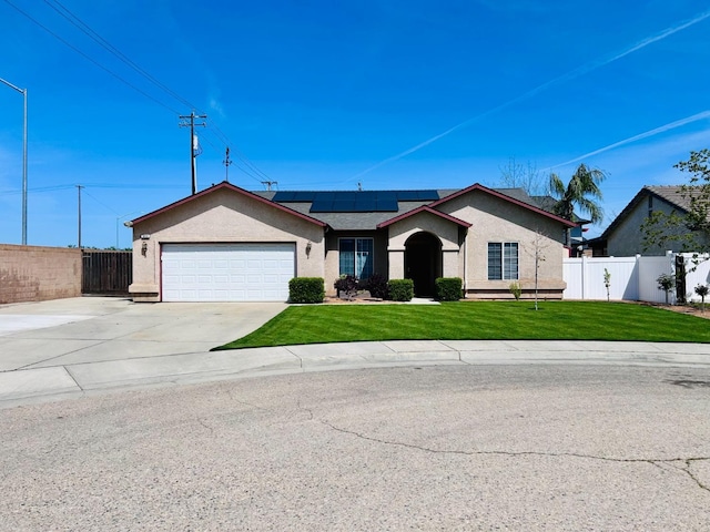 683 W Forest St, Kingsburg, CA 93631 - ranch-style house featuring stucco siding, fence, a front yard, and solar panels