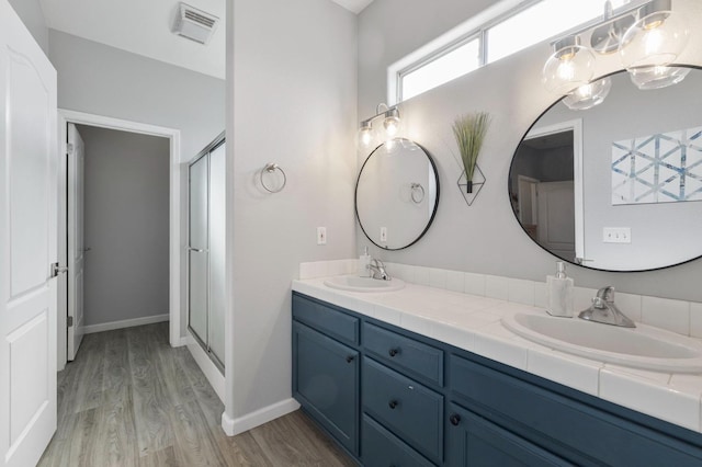 683 W Forest St, Kingsburg, CA 93631 - full bath with a sink, double vanity, wood finished floors, and visible vents