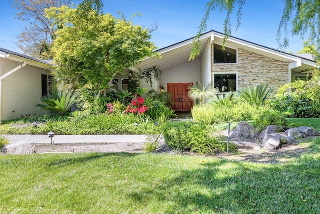 8683 N Colfax Ave, Fresno, CA 93720 - rear view of property featuring a lawn, stucco siding, and stone siding