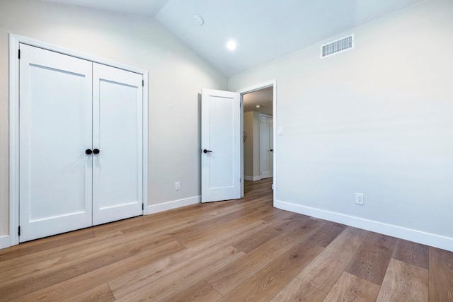 8683 N Colfax Ave, Fresno, CA 93720 - unfurnished bedroom with light wood-style flooring, baseboards, lofted ceiling, visible vents, and a closet