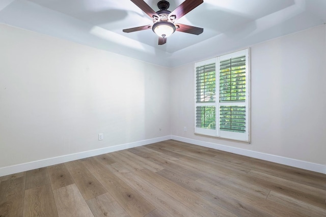8683 N Colfax Ave, Fresno, CA 93720 - unfurnished room with baseboards, a ceiling fan, wood finished floors, and a tray ceiling