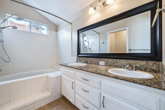 6187 W Alluvial Ave, Fresno, CA 93722 - full bathroom featuring tiled shower / bath combo, vaulted ceiling, double vanity, and tile patterned flooring