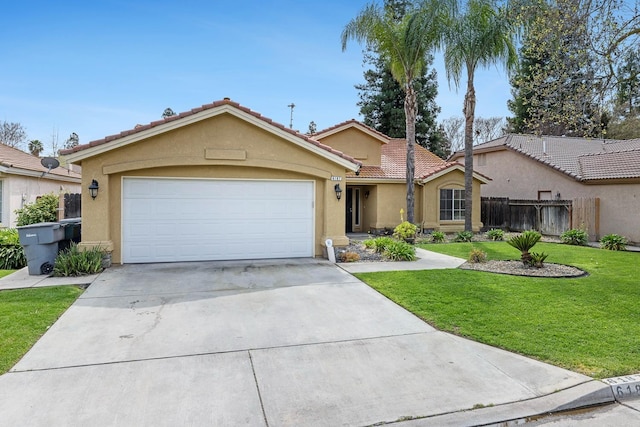6187 W Alluvial Ave, Fresno, CA 93722 - view of front of house with stucco siding, driveway, an attached garage, and a tiled roof