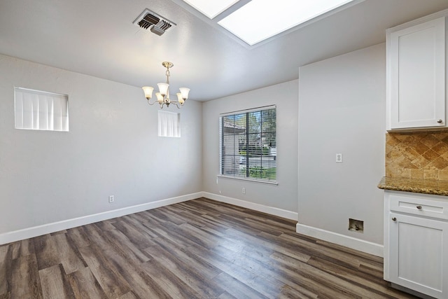 6187 W Alluvial Ave, Fresno, CA 93722 - unfurnished dining area with dark wood-style flooring and a chandelier
