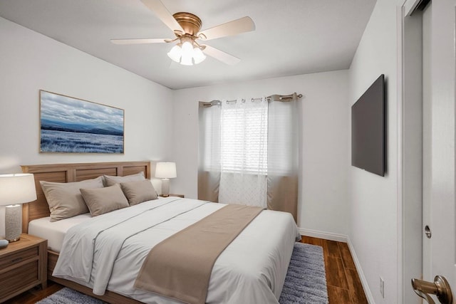 bedroom with dark wood-style flooring, baseboards, and ceiling fan