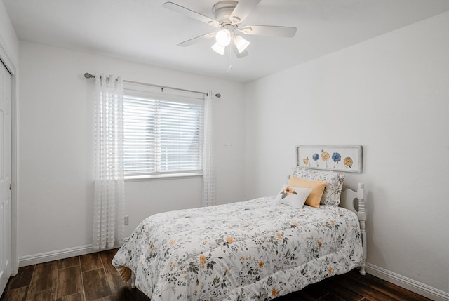 bedroom with wood finished floors, baseboards, and a ceiling fan