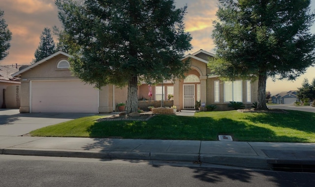 view of property hidden behind natural elements featuring stucco siding, an attached garage, a lawn, and concrete driveway