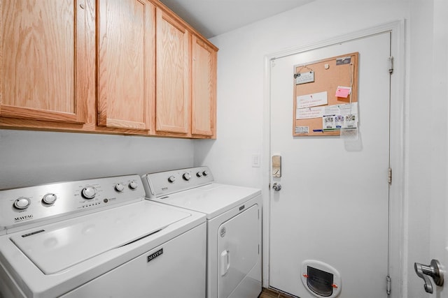 clothes washing area with washing machine and clothes dryer and cabinet space