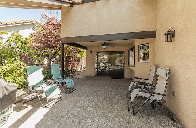 view of patio / terrace featuring fence and a ceiling fan