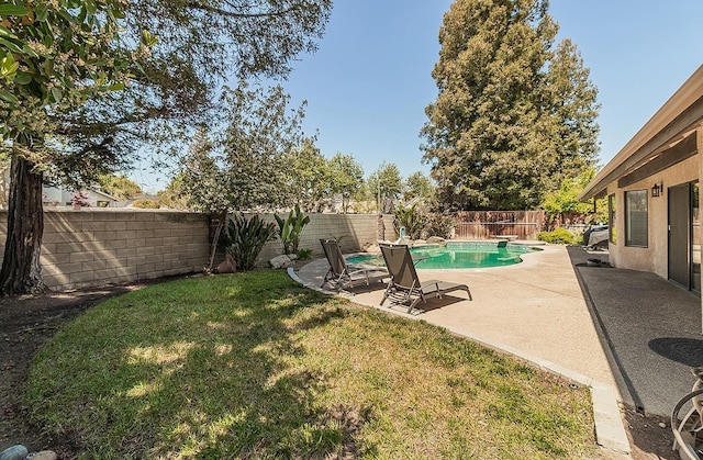 view of yard featuring a fenced backyard, a fenced in pool, and a patio