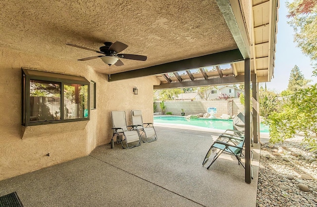 view of patio with a ceiling fan, a fenced in pool, and a fenced backyard