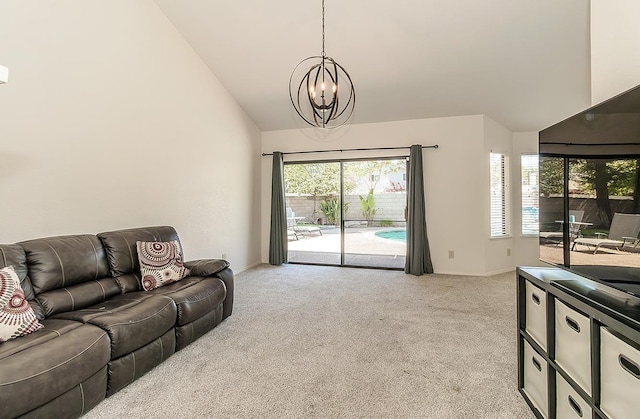 living room with baseboards, a wealth of natural light, a chandelier, and light colored carpet
