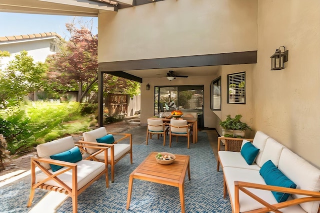 view of patio featuring an outdoor hangout area, outdoor dining space, fence, and ceiling fan