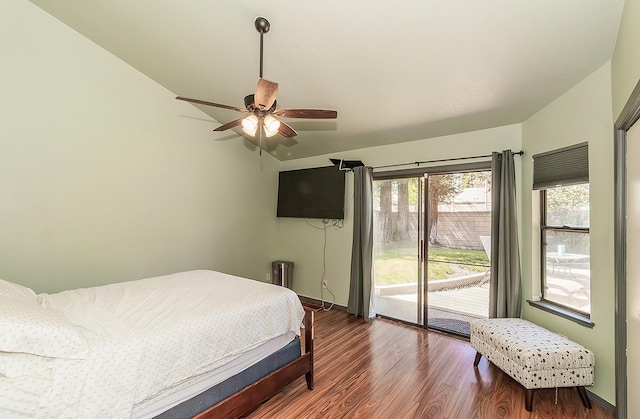 bedroom featuring dark wood-type flooring, a ceiling fan, baseboards, and access to outside