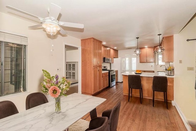 dining room featuring wood finished floors, recessed lighting, and ceiling fan