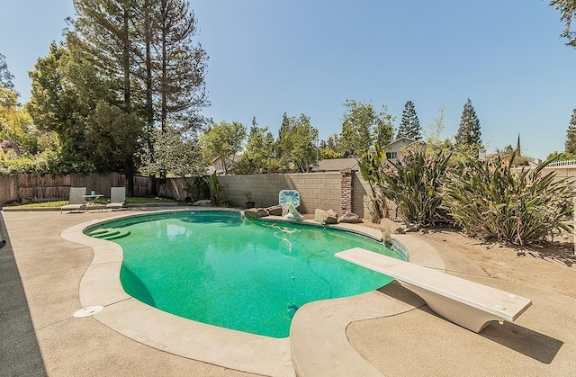 view of pool featuring a fenced backyard, a diving board, a patio area, and a fenced in pool