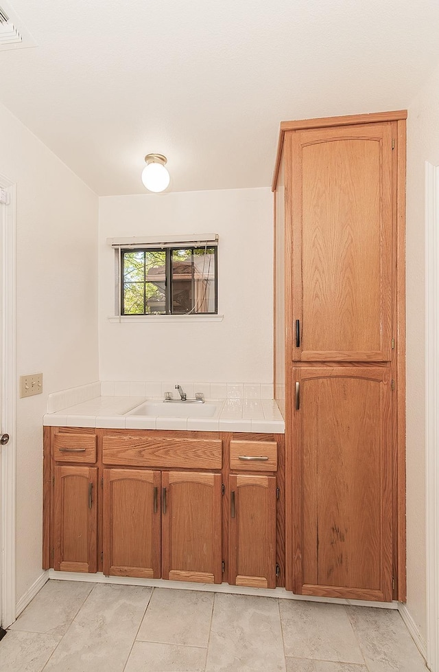 bathroom featuring tile patterned flooring, vanity, and visible vents