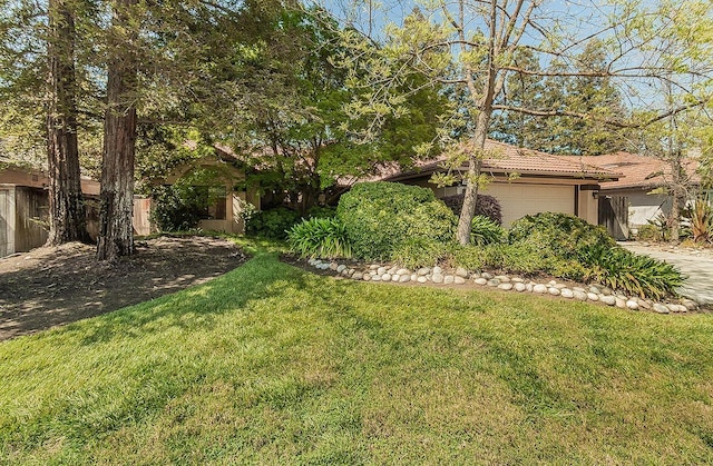 exterior space with fence, driveway, and a garage