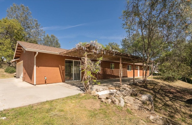 31200 Revis Rd, Coarsegold, CA 93614 - rear view of house featuring an attached garage, a patio, driveway, and stucco siding