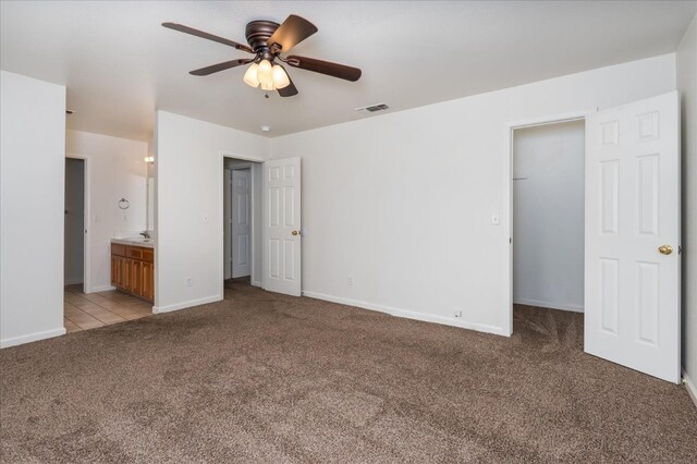 31200 Revis Rd, Coarsegold, CA 93614 - unfurnished bedroom with baseboards, light carpet, a spacious closet, visible vents, and a sink