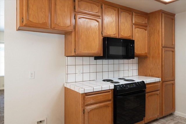 31200 Revis Rd, Coarsegold, CA 93614 - kitchen featuring tasteful backsplash, tile counters, baseboards, and black appliances