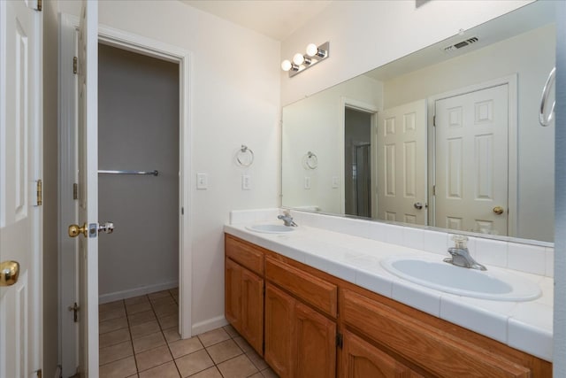 31200 Revis Rd, Coarsegold, CA 93614 - bathroom with tile patterned floors, double vanity, a sink, and visible vents