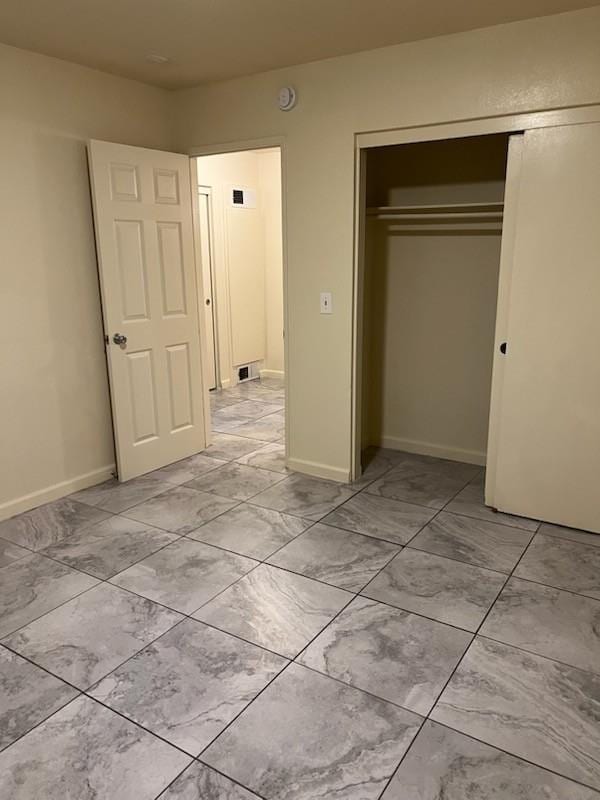 1523 E 85th St, Los Angeles, CA 90001 - unfurnished bedroom featuring a closet and baseboards