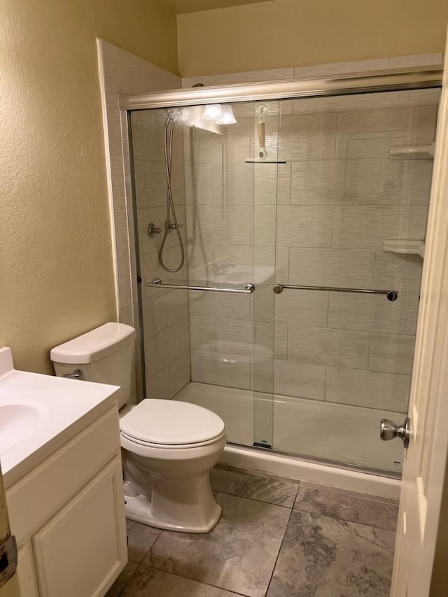 1523 E 85th St, Los Angeles, CA 90001 - bathroom with vanity, a shower stall, and a textured wall