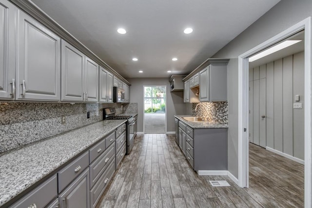 7560 N Charles Ave Unit C, Fresno, CA 93711 - kitchen with a sink, appliances with stainless steel finishes, wood finished floors, and gray cabinetry