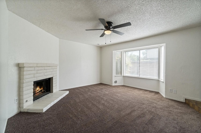 unfurnished living room featuring a fireplace, carpet, a textured ceiling, and ceiling fan