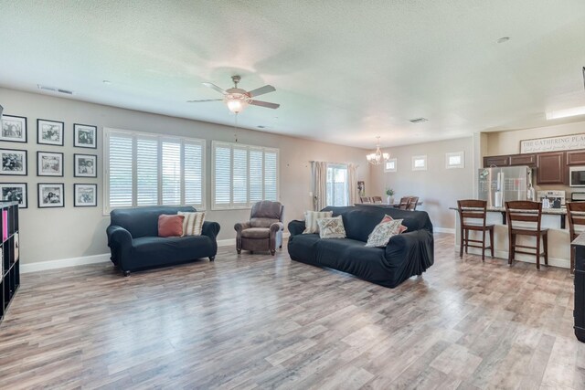2960 3rd St, Sanger, CA 93657 - living area featuring light wood finished floors, a chandelier, a ceiling fan, and baseboards