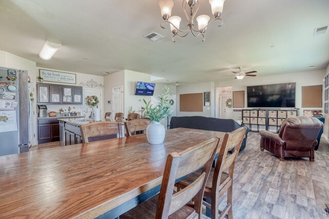 2960 3rd St, Sanger, CA 93657 - dining room with a chandelier, light wood-style flooring, and a ceiling fan