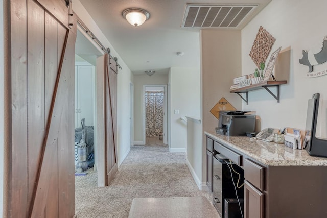 2960 3rd St, Sanger, CA 93657 - corridor featuring light colored carpet, a barn door, and baseboards
