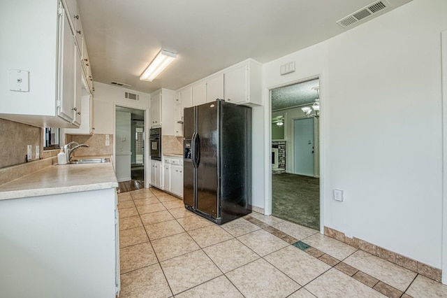 3907 E Dayton Ave, Fresno, CA 93726 - kitchen featuring black appliances, a sink, light tile patterned floors, and light countertops