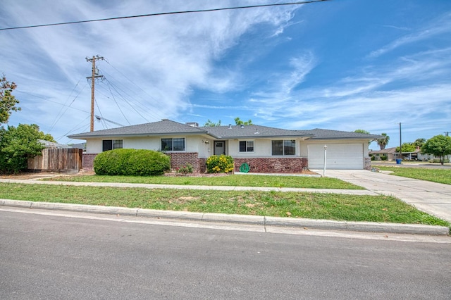 3907 E Dayton Ave, Fresno, CA 93726 - ranch-style home with an attached garage, driveway, and brick siding