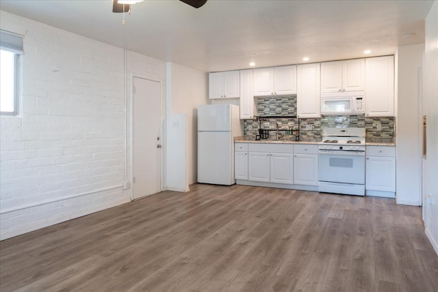kitchen featuring white appliances, white cabinetry, wood finished floors, and ceiling fan