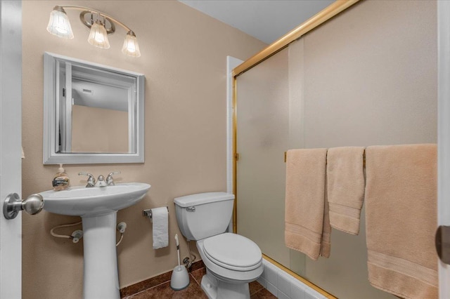 9202 E Herndon Ave, Clovis, CA 93619 - bathroom with a shower stall, toilet, tile patterned flooring, baseboards, and a sink