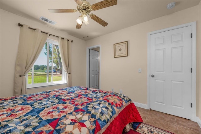 9202 E Herndon Ave, Clovis, CA 93619 - bedroom with tile patterned floors, baseboards, and a ceiling fan
