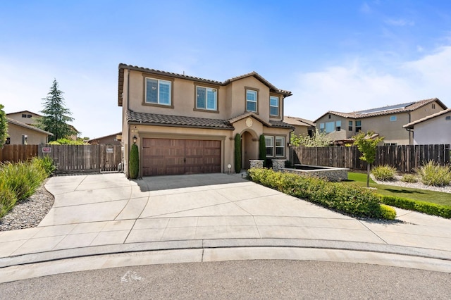 1905 E Via Fiore Ave, Fresno, CA 93730 - view of front of home featuring stucco siding, fence, a tile roof, an attached garage, and concrete driveway