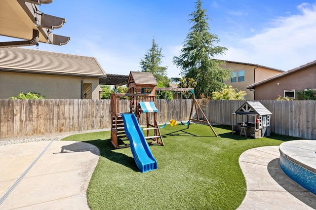 1905 E Via Fiore Ave, Fresno, CA 93730 - view of play area featuring a yard, a fenced backyard, and a patio area