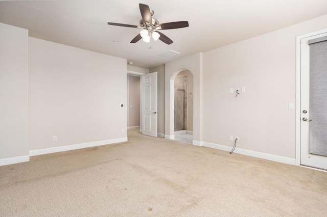1905 E Via Fiore Ave, Fresno, CA 93730 - empty room with ceiling fan, arched walkways, light carpet, and baseboards