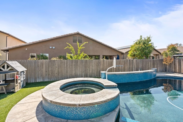 1905 E Via Fiore Ave, Fresno, CA 93730 - view of pool with a fenced backyard and a pool with connected hot tub