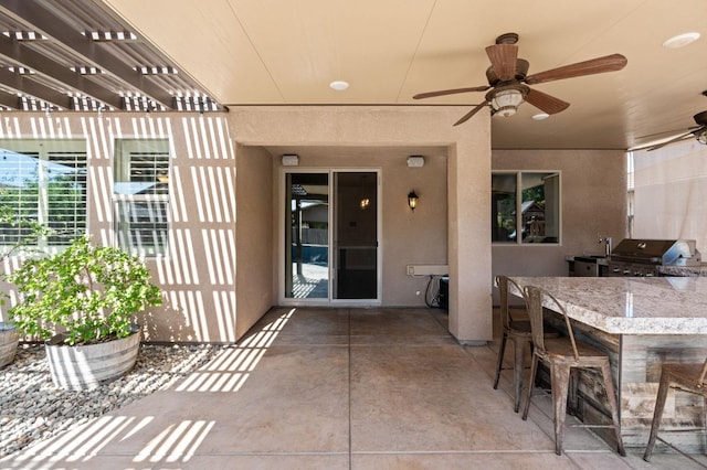 1905 E Via Fiore Ave, Fresno, CA 93730 - view of patio / terrace with a pergola, ceiling fan, outdoor wet bar, grilling area, and an outdoor kitchen