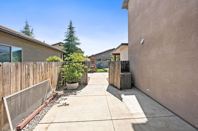 1905 E Via Fiore Ave, Fresno, CA 93730 - view of patio / terrace featuring cooling unit, a fenced backyard, and a playground