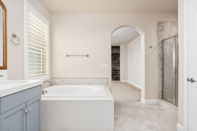 1905 E Via Fiore Ave, Fresno, CA 93730 - full bath with baseboards, a shower stall, vanity, and a garden tub