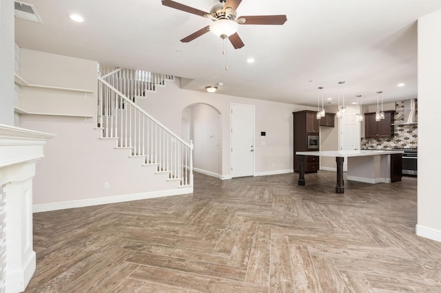 1905 E Via Fiore Ave, Fresno, CA 93730 - unfurnished living room featuring a ceiling fan, visible vents, recessed lighting, stairs, and baseboards
