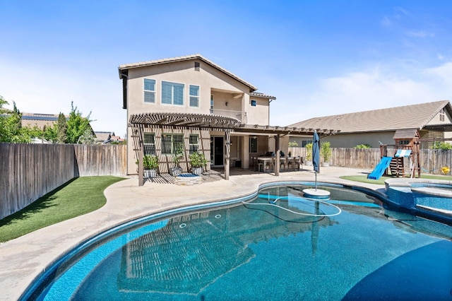 1905 E Via Fiore Ave, Fresno, CA 93730 - rear view of house featuring a pergola, a fenced backyard, stucco siding, a patio, and a playground