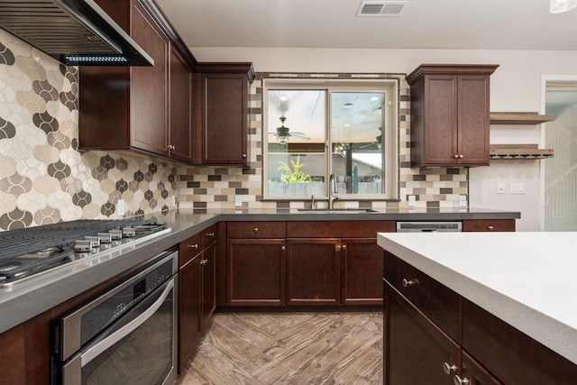 1905 E Via Fiore Ave, Fresno, CA 93730 - kitchen featuring visible vents, open shelves, wall chimney exhaust hood, a sink, and stainless steel appliances