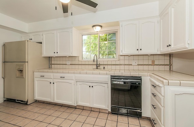 9798 S Thompson, Selma, CA 93662 - kitchen with a sink, black dishwasher, light tile patterned floors, white cabinets, and white refrigerator with ice dispenser