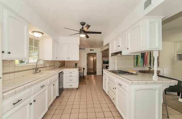 9798 S Thompson, Selma, CA 93662 - kitchen featuring stainless steel cooktop, a ceiling fan, tile counters, and a sink
